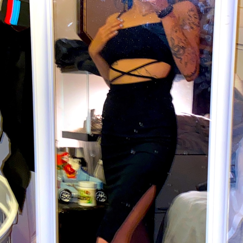 Long tight black dress with a little skin showing